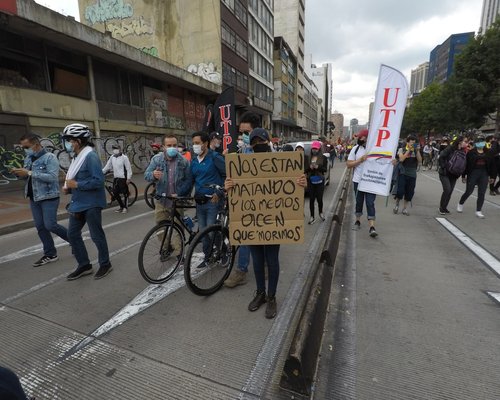 People using a bike lane (ciclovia) in a Colombian city during weekend